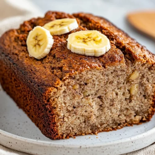 Best Paleo Almond Flour Banana Bread Recipe For Healthy Baking 2 Slice Of Paleo Almond Flour Banana Bread On A White Plate, Garnished With Banana Slices And Cinnamon