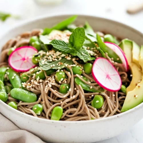 Healthy Sesame Soba Noodles Salad With Fresh Veggies 2 Colorful Sesame Soba Noodles Salad In A White Bowl Garnished With Avocado, Radish, And Mint Leaves