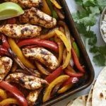Delicious Sheet Pan Chicken Fajitas With Bell Peppers And Fresh Cilantro On A White Plate