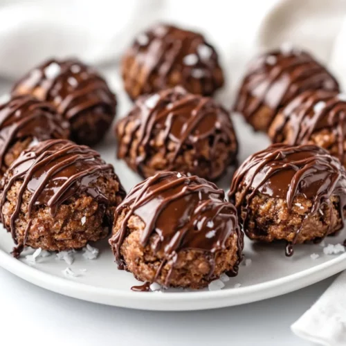 Vegan Chocolate Macaroons: Easy, Gluten-Free &Amp; Healthy Treats 2 Vegan Chocolate Macaroons Drizzled With Dairy-Free Chocolate On A White Plate, Garnished With Shredded Coconut.