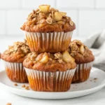 Delicious Apple Spice Muffins Stacked On A White Plate, Showcasing Grated Apple And Warm Cinnamon.