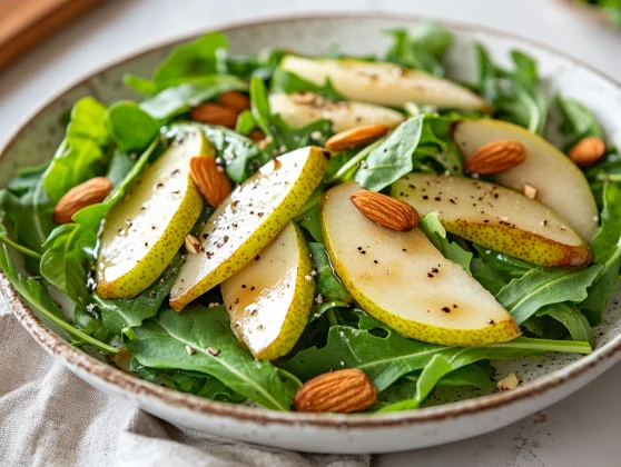 Asiago Arugula Salad With Pears - Healthy And Delicious Recipe 2 Asiago Arugula Salad With Pears, Avocado, And Toasted Almonds On A White Plate Garnished With Basil