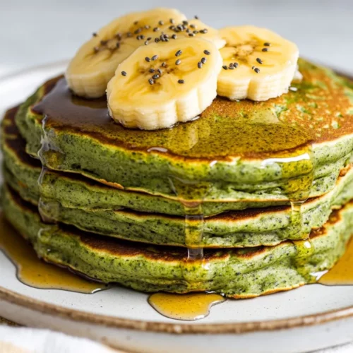 Banana Spinach Pancakes: Healthy, Delicious, And Gluten-Free 2 Stack Of Banana Spinach Pancakes On A White Plate, Drizzled With Syrup And Topped With Banana Slices And Chia Seeds