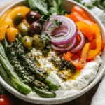 Bbq Cottage Cheese Bowl With Grilled Vegetables, Pickled Onions, And Pesto On A White Plate