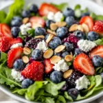 Vibrant Blueberry Goat Cheese Salad With Fresh Greens, Strawberries, And Blueberries On A White Bowl