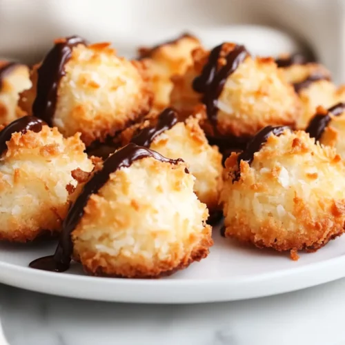 Plate Of Golden Coconut Macaroons Drizzled With Dark Chocolate, Showcasing Their Crispy Texture