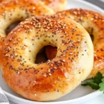 Golden Easy Homemade Bagels On A White Plate, Topped With Everything Seasoning And Garnished With Parsley