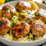 Plate Of Greek Chicken Meatballs With Orzo In Lemon Sauce, Garnished With Parsley And Lemon Slices
