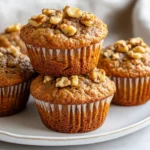 Delicious Healthy Banana Muffins On A White Plate Topped With Walnuts And Showcasing A Soft, Moist Texture