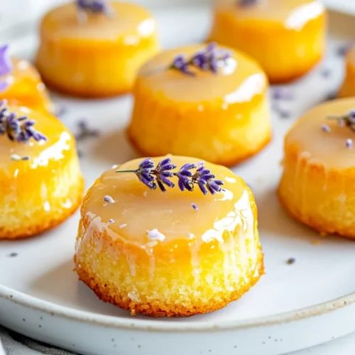 Mini Lemon Cakes With Lavender Glaze: An Elegant, Healthy Dessert 2 Mini Lemon Cakes With Lavender Glaze On A White Plate, Topped With Edible Lavender Flowers And Lemon Zest.