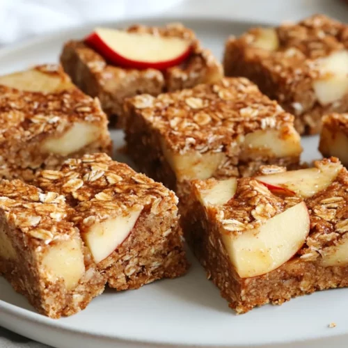 Delicious Oat And Fruit Bars On A White Plate, Garnished With Fresh Fruit Slices, Showcasing Their Chewy Texture.