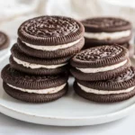 Stack Of Old School Homemade Oreos On A White Plate, Showcasing Creamy Filling And Chewy Texture