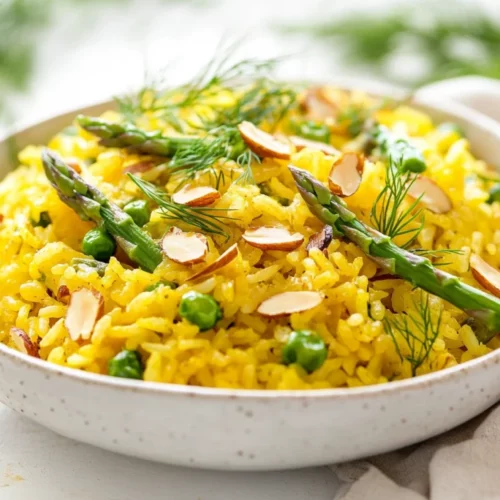 Saffron Almond Asparagus Pilaf - Healthy And Easy Recipe 2 Delicious Saffron Almond Asparagus Pilaf In A White Bowl, Garnished With Fresh Herbs And Almonds