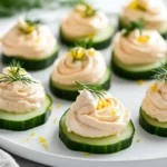 Delicious Salmon Mousse Canapes On A White Plate, Garnished With Fresh Dill And Lemon Zest