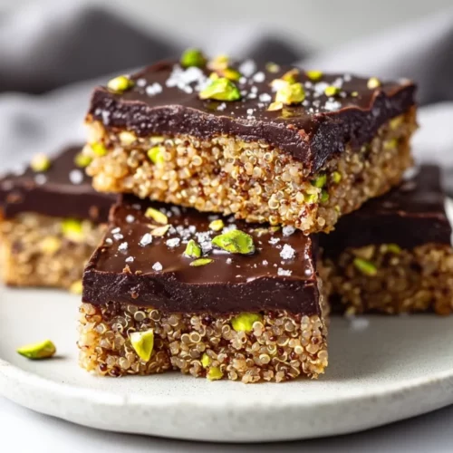 Salted Dark Chocolate Pistachio Quinoa Bars: A Healthy Snack You'Ll Love 2 Delicious Salted Dark Chocolate Pistachio Quinoa Bars On A White Plate, Garnished With Chopped Pistachios And Sea Salt