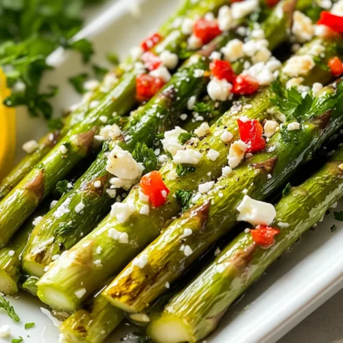 Sautéed Asparagus With Garlic: Quick, Flavorful, And Healthy 2 Sautéed Asparagus With Garlic On A White Plate, Topped With Feta Cheese And Roasted Red Peppers