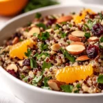 Colorful Wild Rice Quinoa Salad With Cranberries And Oranges In A White Bowl, Garnished With Parsley