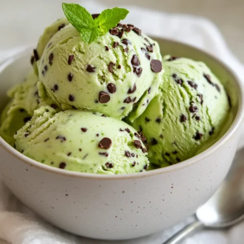 Bowl Of Avocado Ice Cream Mint Chocolate Chip Garnished With Mint Leaves And Dark Chocolate Chips