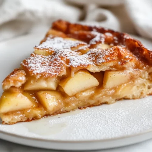 Healthy Baked Apple French Toast Recipe For A Wholesome Breakfast 2 Baked Apple French Toast On A White Plate, Dusted With Powdered Sugar And Drizzled With Almond Milk Glaze.