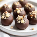 Plate Of Banana Chocolate Hazelnut Bites Garnished With Banana Slices And Crushed Hazelnuts