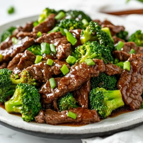 Healthy Beef And Broccoli Stir Fry Recipe For A Quick, Nutritious Meal 2 Colorful Beef And Broccoli Stir Fry On A White Plate Garnished With Green Onions, Showcasing Tender Beef And Vibrant Broccoli