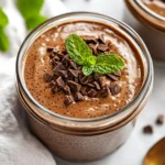 Creamy Chocolate Chia Seed Pudding In A Glass Jar Drizzled With Maple Syrup And Garnished With Mint Leaves