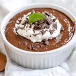 Creamy Dark Chocolate Peanut Butter Pudding Topped With Whipped Cream And Chocolate Shavings In A White Bowl