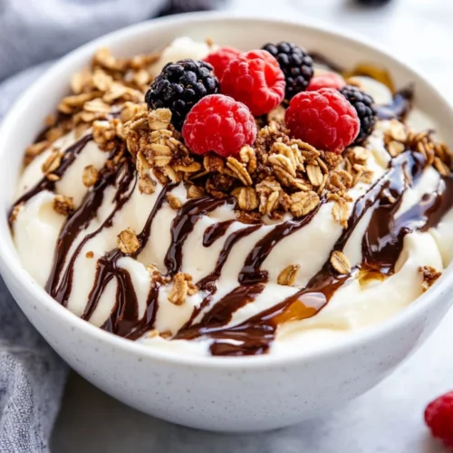 Frozen Cottage Cheese Dessert: A Healthy, Protein-Packed Treat 2 Frozen Cottage Cheese Dessert In A White Bowl, Swirled With Chocolate And Topped With Granola And Fresh Berries