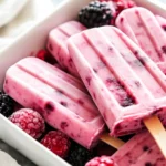 Colorful Greek Yogurt Popsicles In A White Bowl, Showcasing Chunks Of Fresh Berries And A Creamy Texture