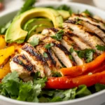 Grilled Chicken Fajita Salad In A White Bowl With Fresh Vegetables And Avocado Slices On A Neutral Background