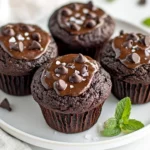 High Protein Chocolate Veggie Muffins On A White Plate, Garnished With Mint Leaves And With Melted Chocolate Chips