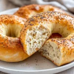 Golden High Protein Cottage Cheese Bagels On A White Plate, Sprinkled With Everything Seasoning
