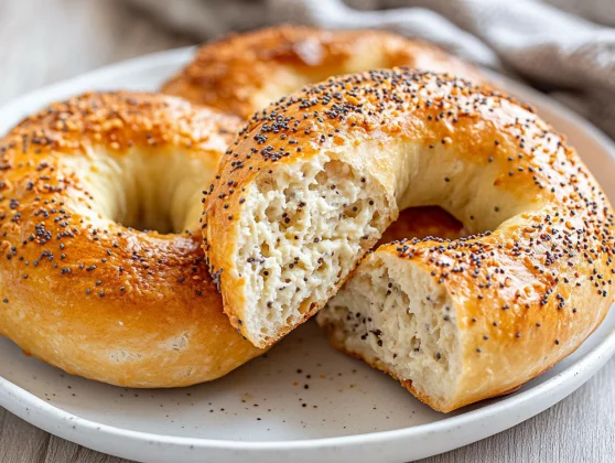 High Protein Cottage Cheese Bagels - Easy Recipe Without Yeast 2 Golden High Protein Cottage Cheese Bagels On A White Plate, Sprinkled With Everything Seasoning