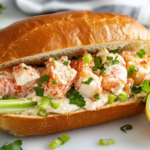 Healthy Lobster Roll Sandwich Recipe | Easy, Delicious &Amp; Nutritious 2 Healthy Lobster Roll Sandwich On A White Plate Garnished With Celery, Scallions, And A Lemon Wedge
