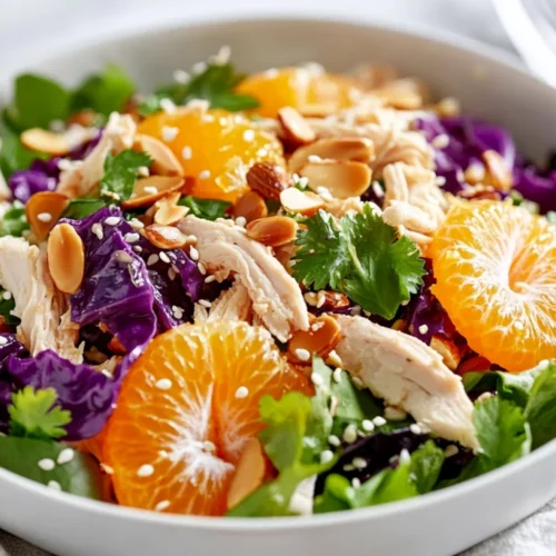 Mandarin Orange Chicken Salad Recipe For A Healthy, Flavorful Meal 2 Mandarin Orange Chicken Salad Served In A White Bowl, Topped With Almonds And Sesame Seeds, Vibrant Colors, Fresh Ingredients.