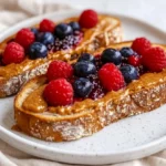 Peanut Butter Chia Jam Toast On A White Plate, Topped With Vibrant Berry Chia Jam And Creamy Peanut Butter.