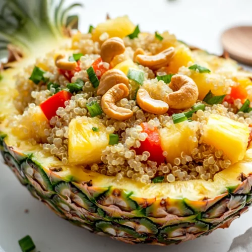 Pineapple Quinoa Bowl: Sweet, Savory, And Nutritious 2 Pineapple Quinoa Bowl In A Pineapple Boat Filled With Quinoa, Fresh Pineapple, And Colorful Vegetables Topped With Cashews