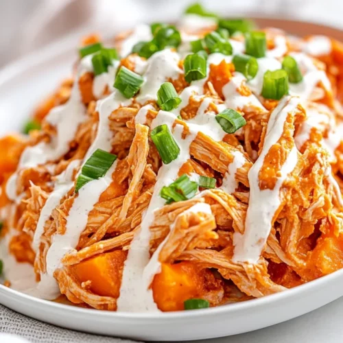 Slow Cooker Buffalo Chicken: A Healthy And Flavorful Recipe 2 Plate Of Slow Cooker Buffalo Chicken Over Baked Sweet Potatoes, Drizzled With Ranch Dressing And Garnished With Green Onions
