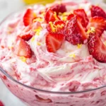 Bowl Of Strawberry Cheesecake Dip Swirled With Preserves, Garnished With Fresh Strawberries And Lemon Zest