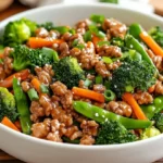 Delicious Teriyaki Turkey Skillet With Colorful Vegetables In A White Bowl, Garnished With Scallions