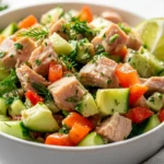 Tuna Avocado Salad In A White Bowl, Garnished With Fresh Dill And Lime, Showcasing Colorful Vegetables