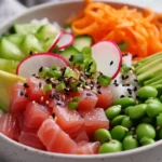 Colorful Tuna Poke Bowl With Sashimi-Grade Tuna, Avocado, And Fresh Veggies On A White Plate