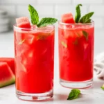 Refreshing Watermelon Mint Juice In Clear Glasses Garnished With Mint Leaves And Watermelon Cubes