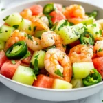 Vibrant Watermelon Shrimp Salad In A White Bowl, Garnished With Fresh Mint, On A Neutral Background